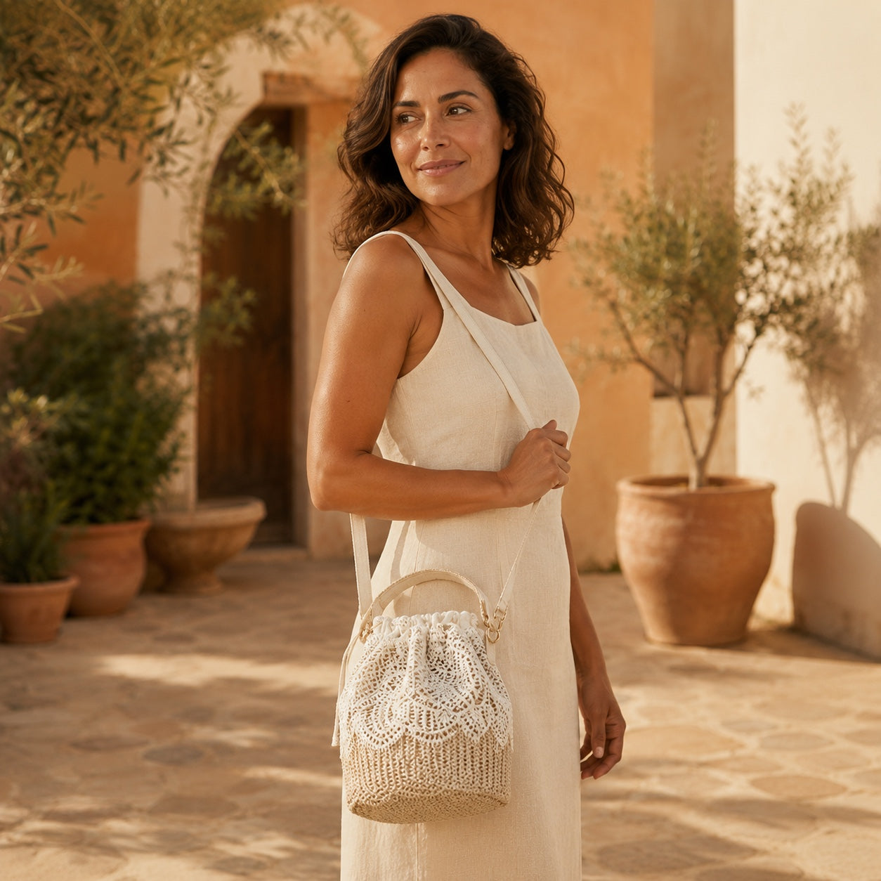Model wearing the Alassio - Straw Crossbody Bag, side view