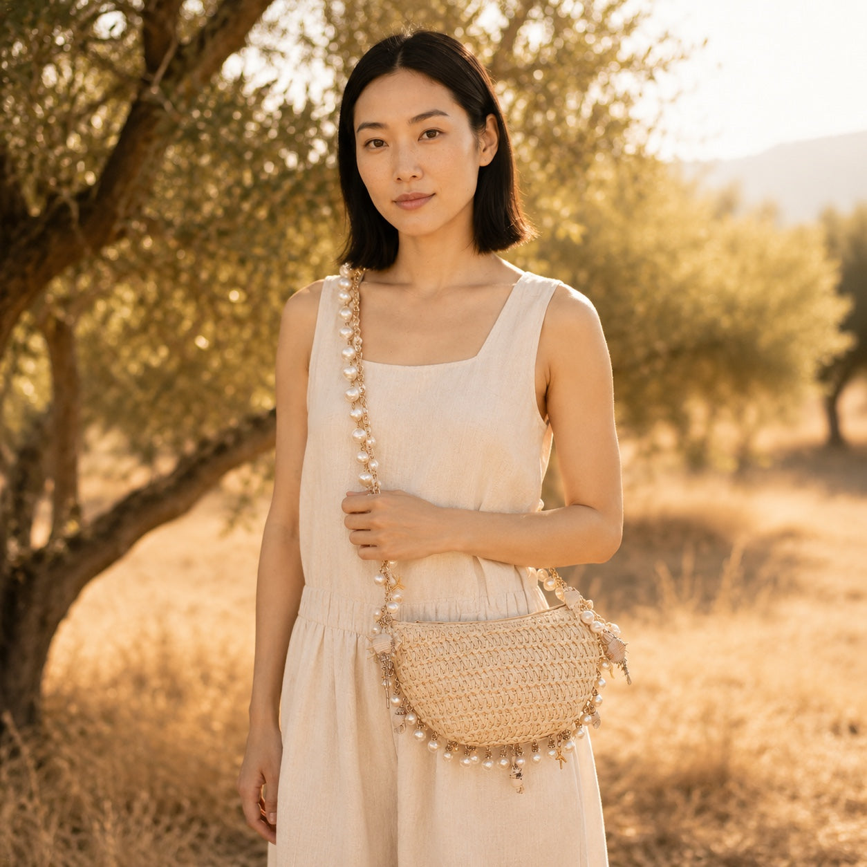Model carrying the Boccadasse - Straw Crossbody Bag