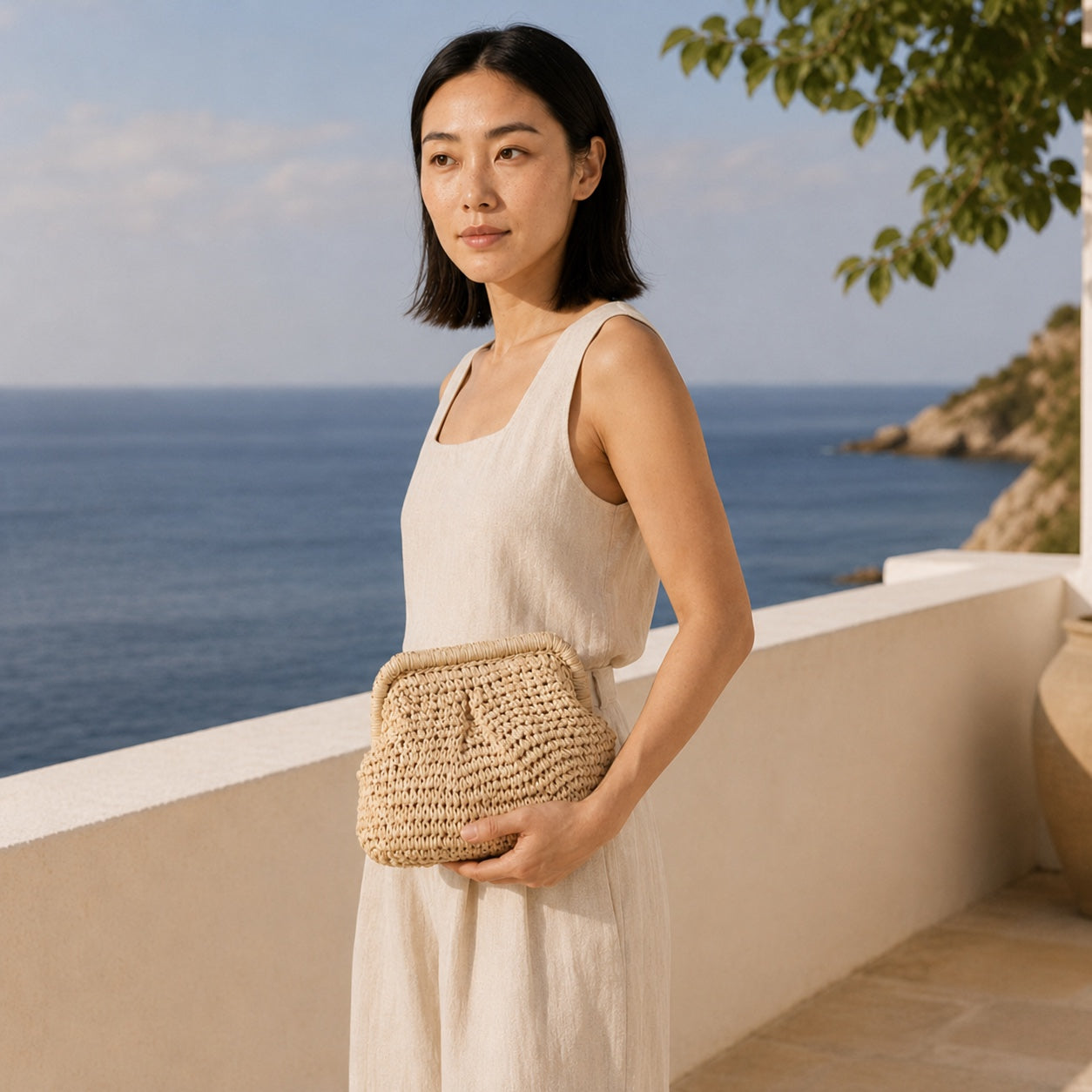 Model wearing the Framura - Straw Clutch, side view