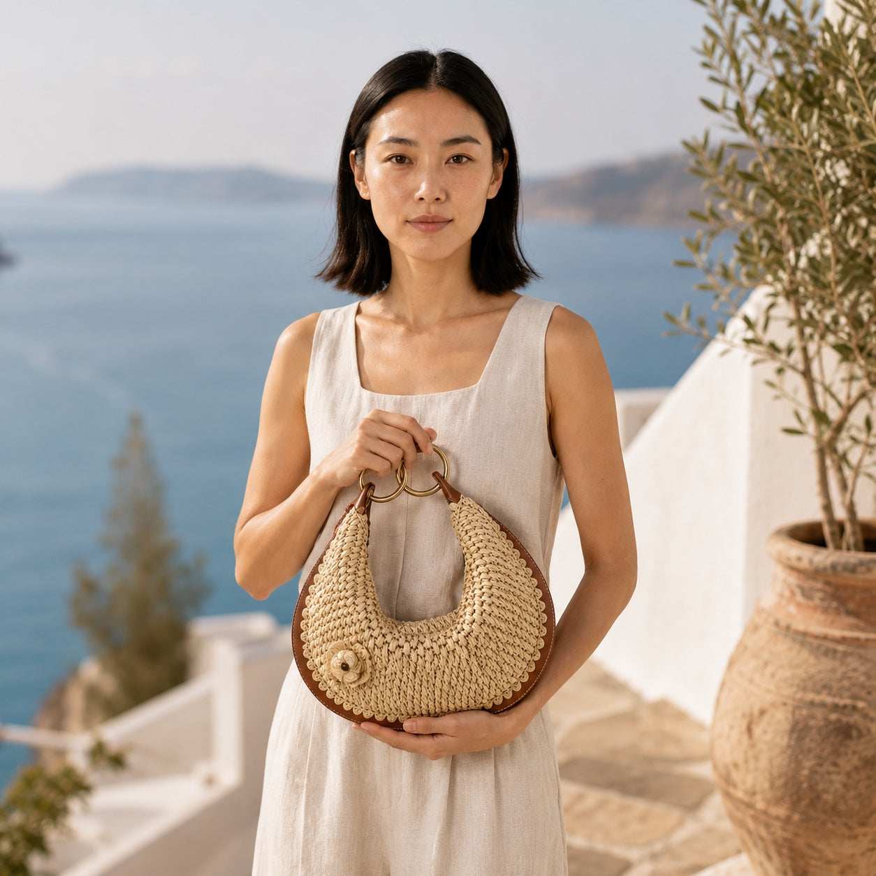 Model carrying the Mykonos - Rattan Clutch