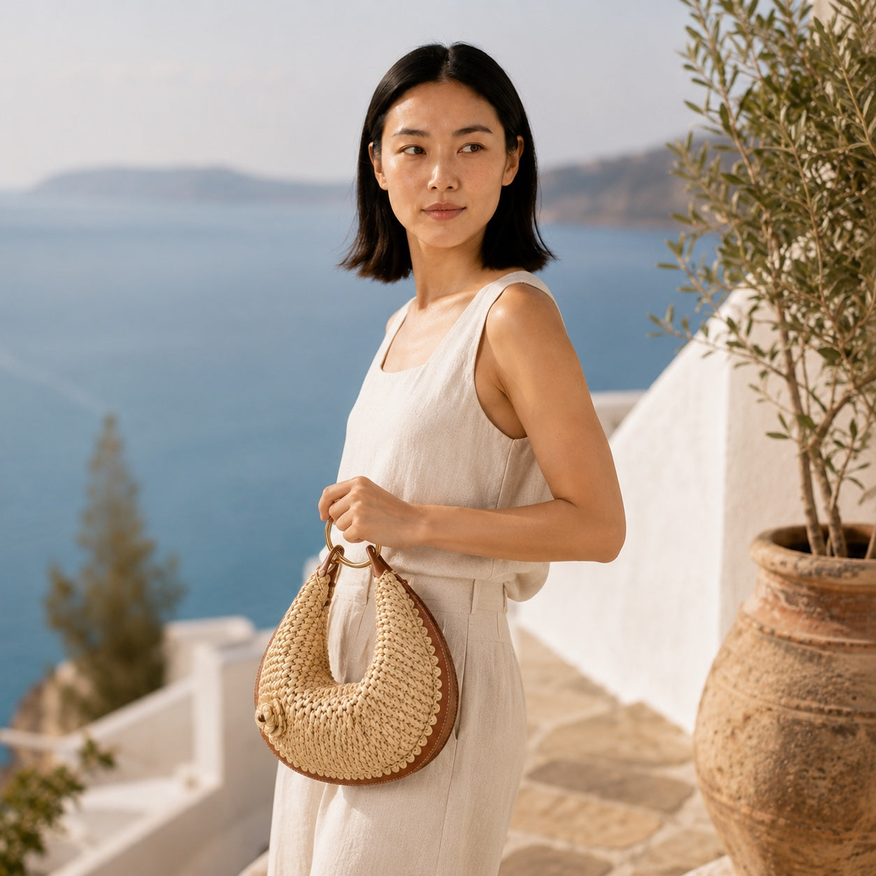 Model wearing the Mykonos - Rattan Clutch, side view