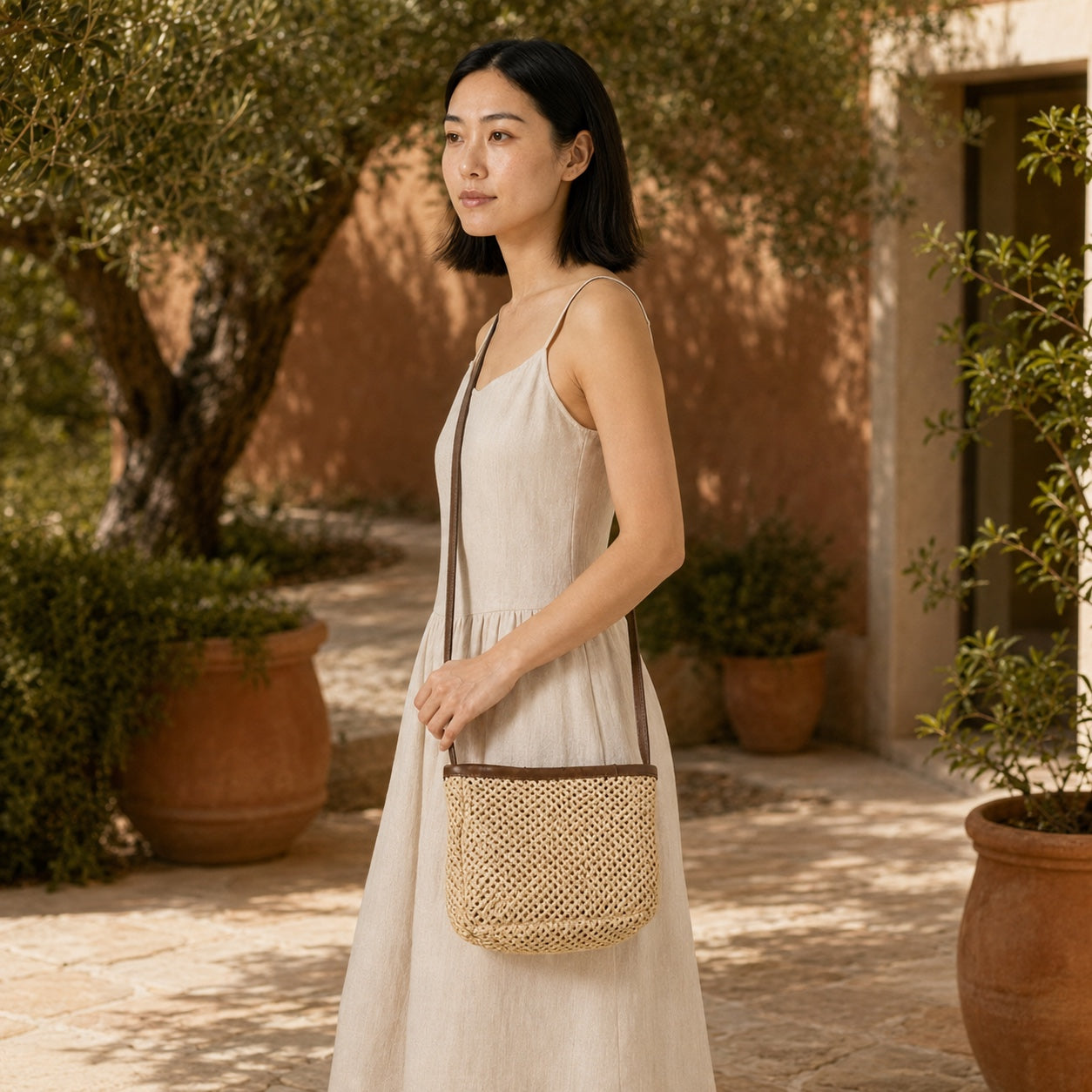 Model wearing the Portinatx - Straw Crossbody Bag in Only Bag, side view