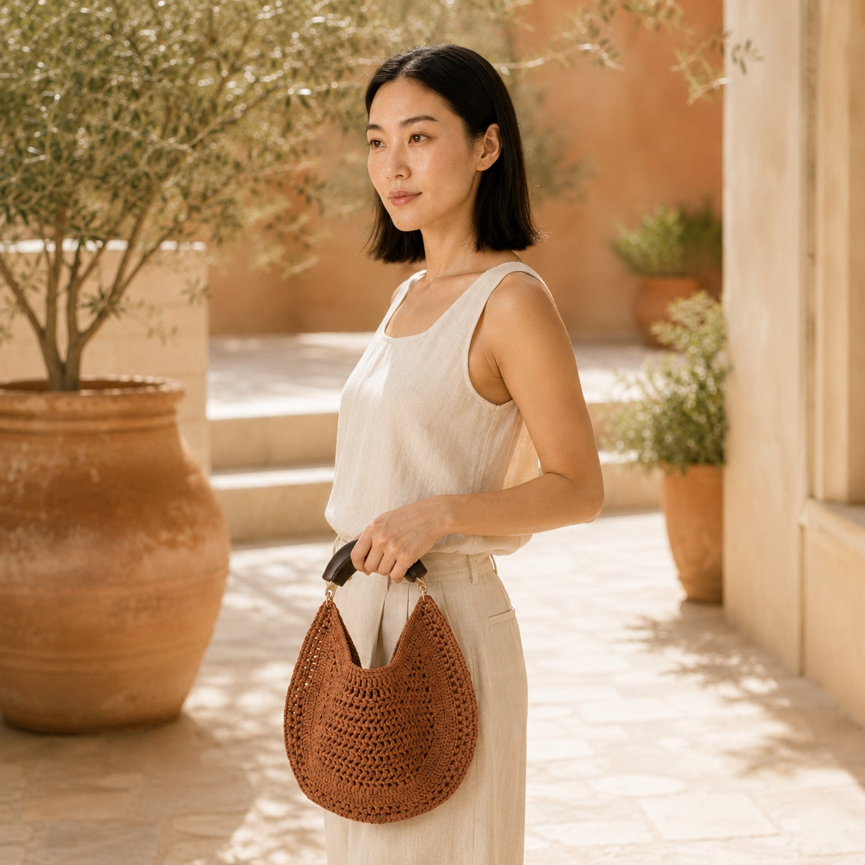 Model wearing the Sagres - Straw Handbag, side view
