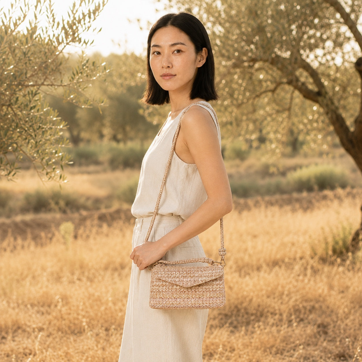 Model wearing the Salina Straw Crossbody Bag, side view