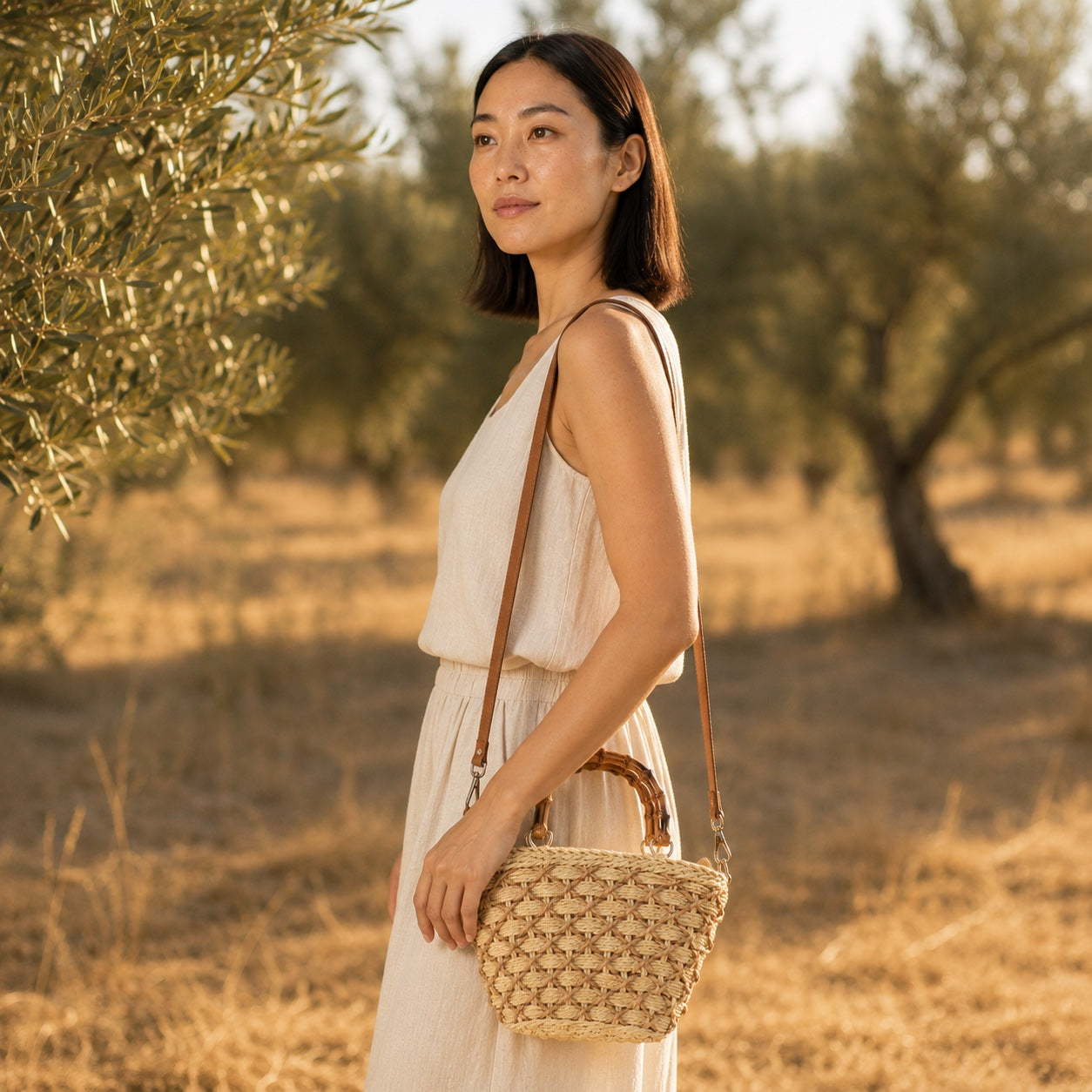 Model wearing the Sifnos - Straw Crossbody Bag, side view