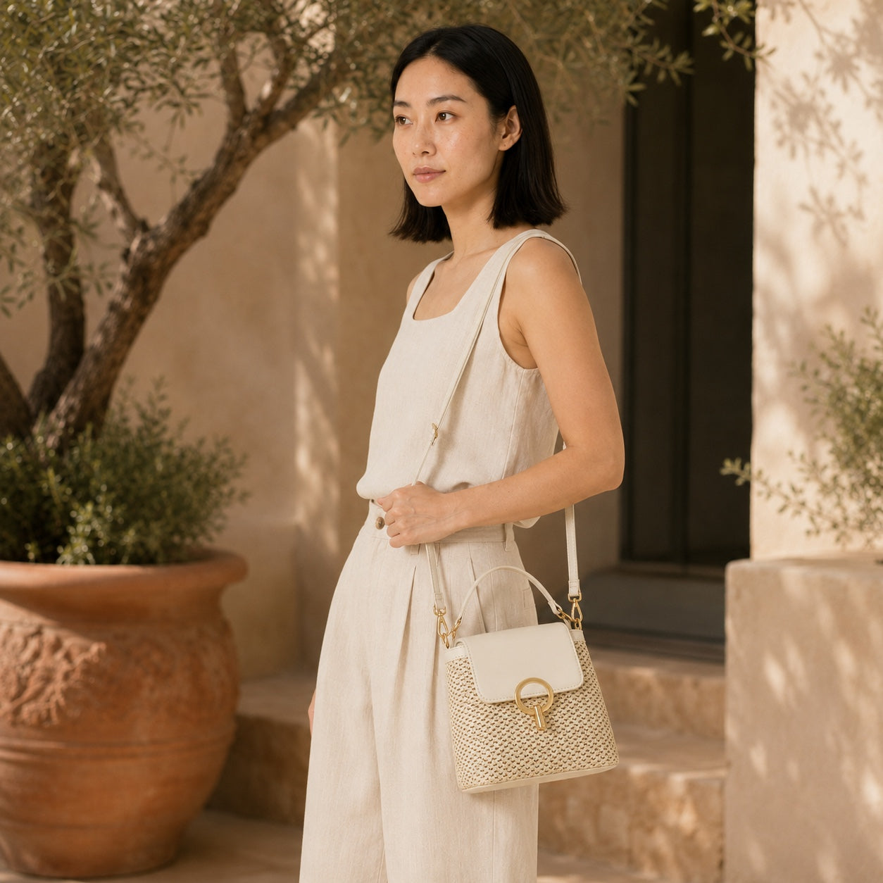 Model wearing the Sveti - Straw Crossbody Bag, side view