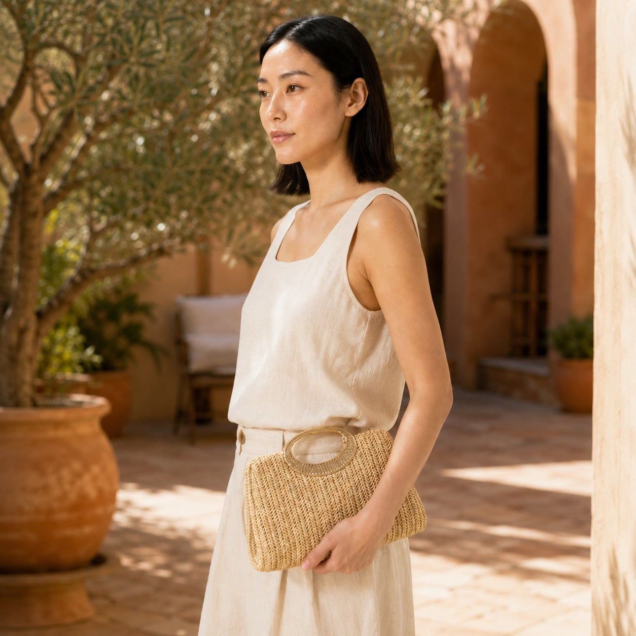 Model wearing the Taggia - Straw Clutch in Khaki, side view